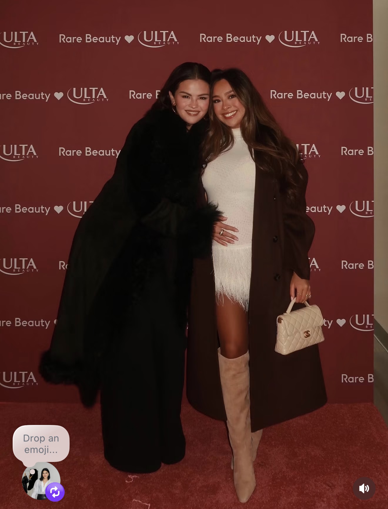 Client at a beauty brand launch in a feathered white dress, long coat, and knee-high boots